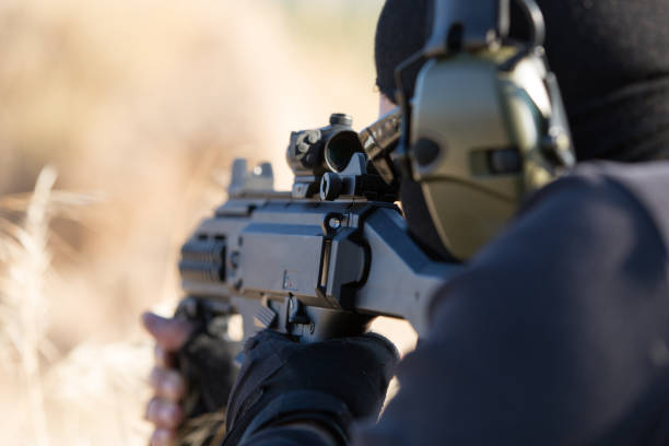 istock man in black  with weapon 688909386