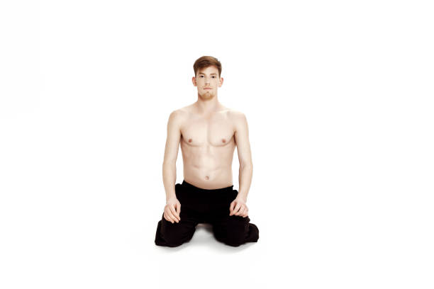 istock Young man doing yoga exercises. Studio shot on white background 688910984