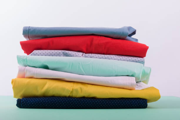 istock Folded colorful pants and jeans. Stack of bright female trousers. Close up. 688911254