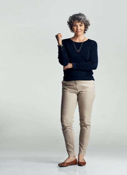 Aging well is all about confidence Studio portrait of a confident mature woman posing against a gray background 50 59 years stock pictures, royalty-free photos & images
