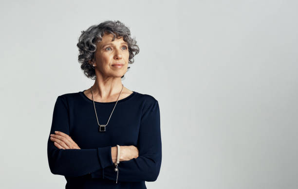 Confident about what has been and what is becoming Studio shot of a thoughtful mature woman posing against a gray background 50 59 years stock pictures, royalty-free photos & images