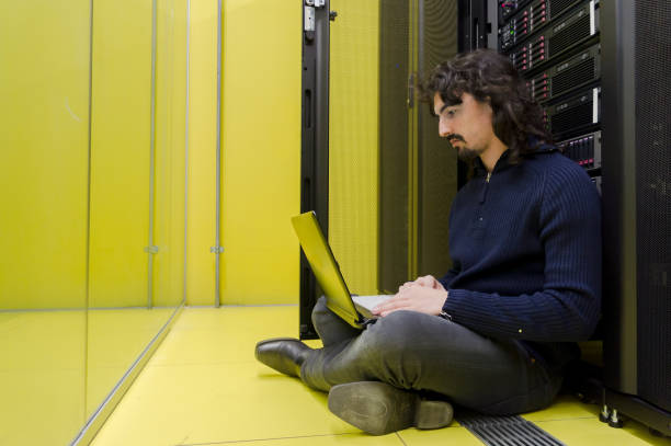 Computer Technician working in datacenter stock photo