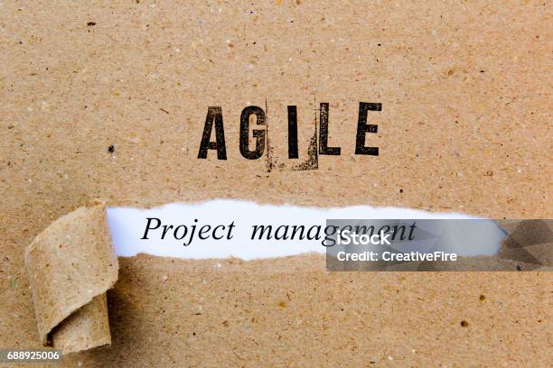 Agile Project Management Printed Text Underneath Torn Brown Paper With Agile Printed In Ink Stock Photo - Download Image Now