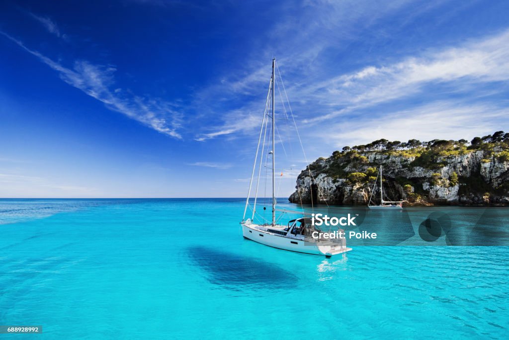 Beautiful bay in Mediterranean sea Beautiful bay with sailing boats, Menorca island, Spain Sailboat Stock Photo