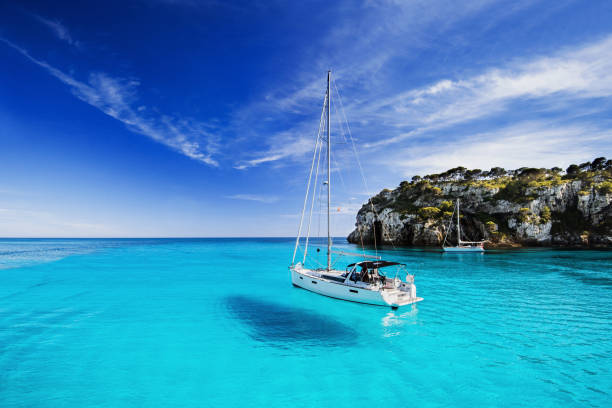 Beautiful bay in Mediterranean sea Beautiful bay with sailing boats, Menorca island, Spain sailboat photos stock pictures, royalty-free photos & images