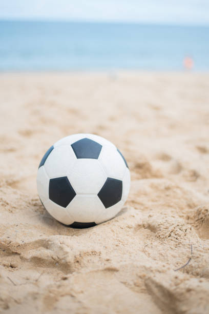 istock Soccer ball on sandy beach after game 688934200