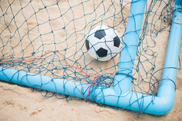istock Soccer ball on sandy beach after game 688934210