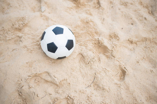 istock Soccer ball on sandy beach after game 688934248