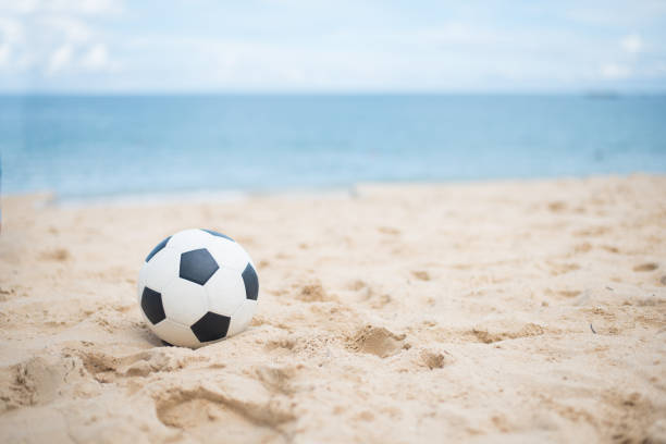 istock Soccer ball on sandy beach after game 688934250