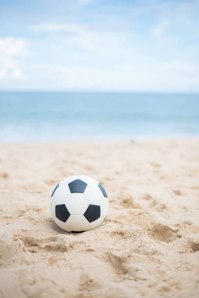 istock Soccer ball on sandy beach after game 688934252