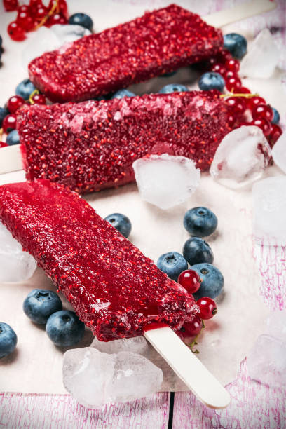 istock Fruit ice cream with raspberries and blueberries on a stick 688934316
