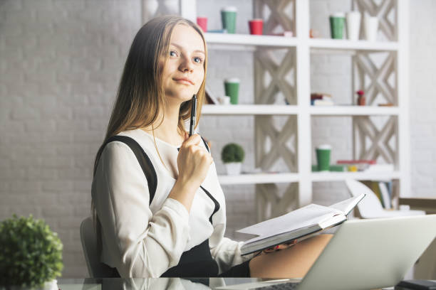 istock Attractive woman reading book 688935400