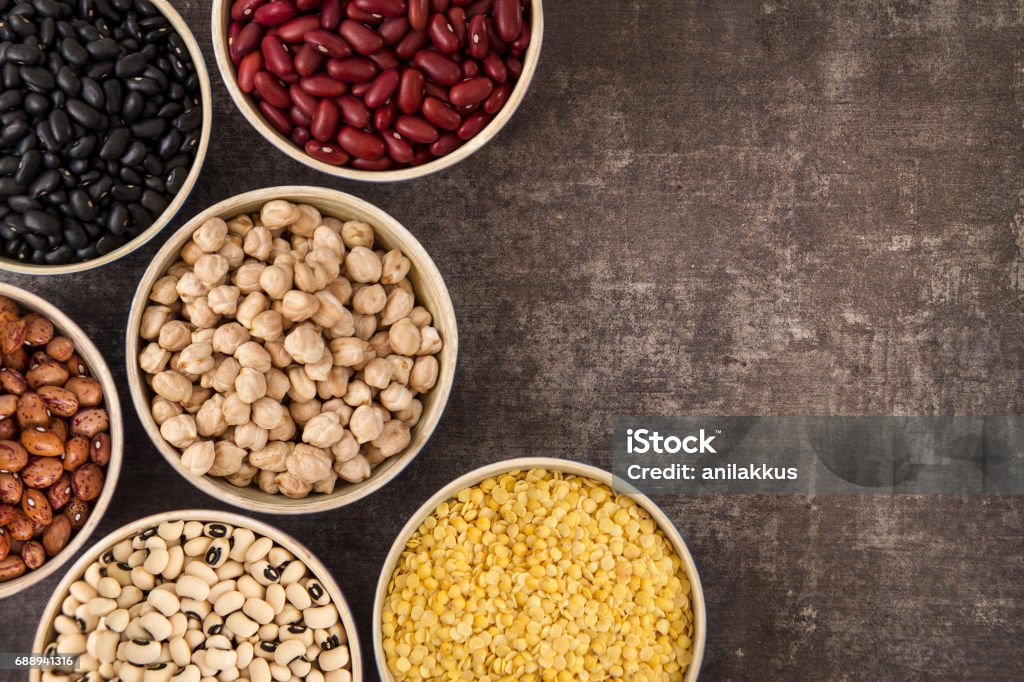 Legumes and Beans Legumes and beans on brown rustic table with copy space. Legume Family Stock Photo