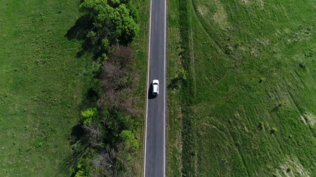 4K Transportation Aerial view white car driving on countryside road