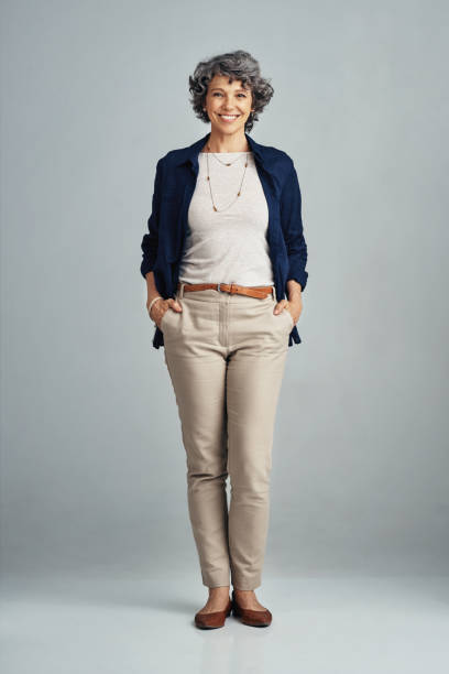 The happiest days of life are right here Studio portrait of a confident mature woman posing against a gray background middle aged woman fashion stock pictures, royalty-free photos & images