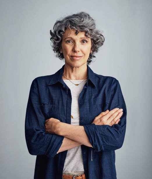 Confident about whatever comes my way Studio portrait of a confident mature woman posing against a gray background grey hair stock pictures, royalty-free photos & images