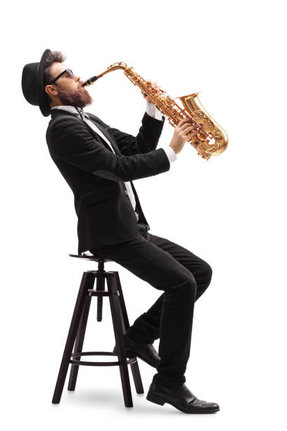 istock Jazz musician seated on a chair playing a saxophone 688948810