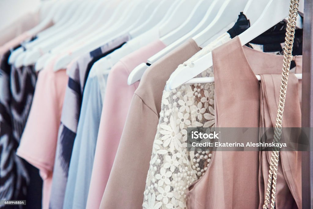 Details of bright beautiful pastel tones dress collection in show room Clothing Stock Photo