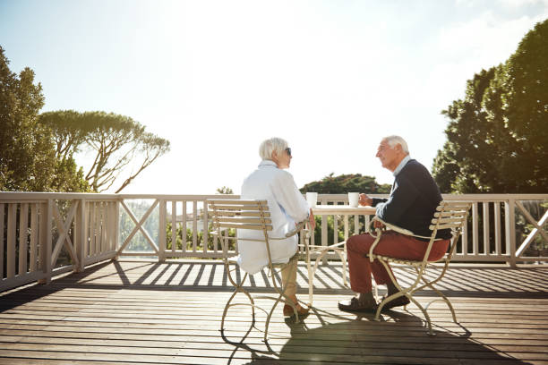 Retirement is a chance to live each day in leisure Shot of a senior couple having coffee together on their balcony at home drinks on the deck stock pictures, royalty-free photos & images