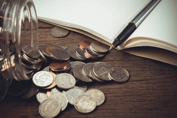 istock money concept coins and pen with filter effect retro vintage style 688951828
