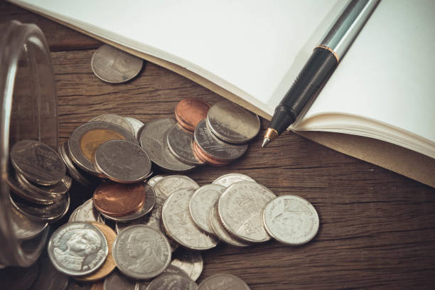 istock money concept coins and pen with filter effect retro vintage style 688951864