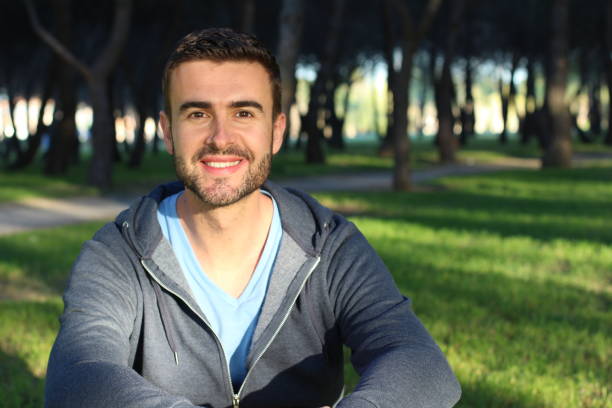 istock Man with perfect smile in the park 688955206
