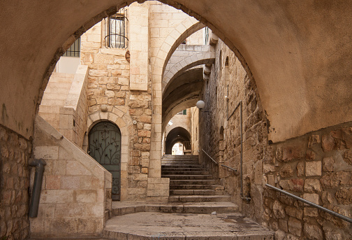 Empty stone alley street among jewish and arab quaretrs of Jerusalem old city next to Western Wall (or Wailing Wall aka Kotel)