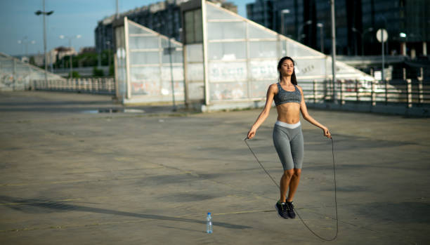 istock Sporty woman jumping rope. 688963124