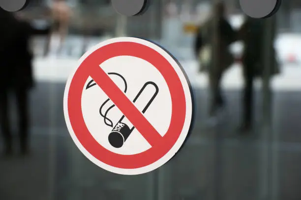 Non-smoking sign on a glass wall as a sign of prohibition