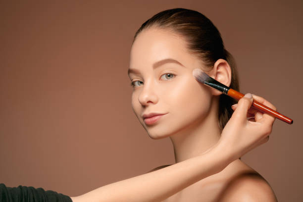 istock Beautiful female eyes with make-up and brush 688963350