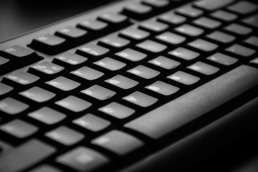Black and white close up of a computer keyboard.