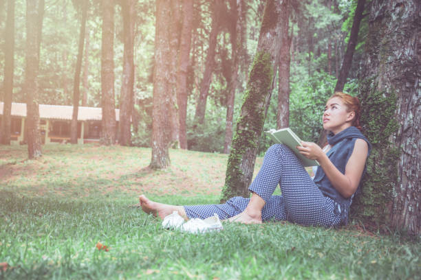 istock Woman relaxing reading in park. holiday 688963446