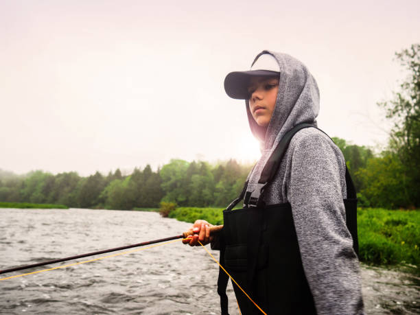 Boy fly-fishing on a trout stream