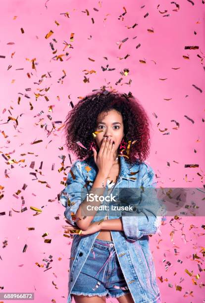 Portrait Of Surprised Young Afro Woman Among Confetti Stock Photo - Download Image Now