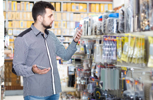istock man deciding on best DIY details in houseware store 688969778
