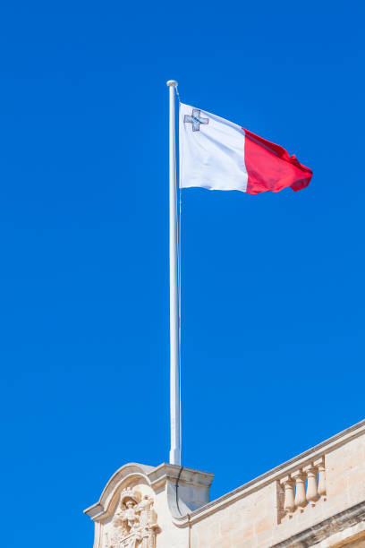 istock Flag of Malta against blue sky during wind 688970528