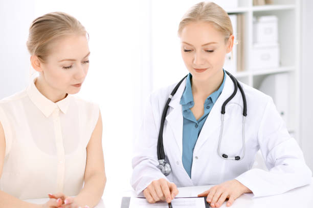 istock Doctor and  patient  sitting at the desk 688974004