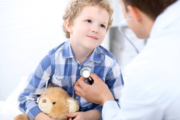istock Doctor examining a child  patient by stethoscope 688980744