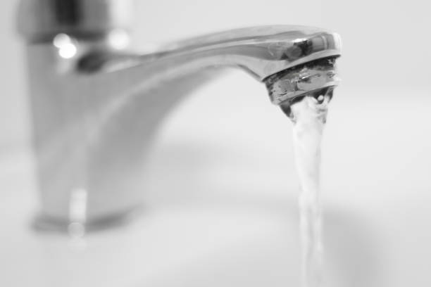 istock Bathroom sink tap with running water 688984636