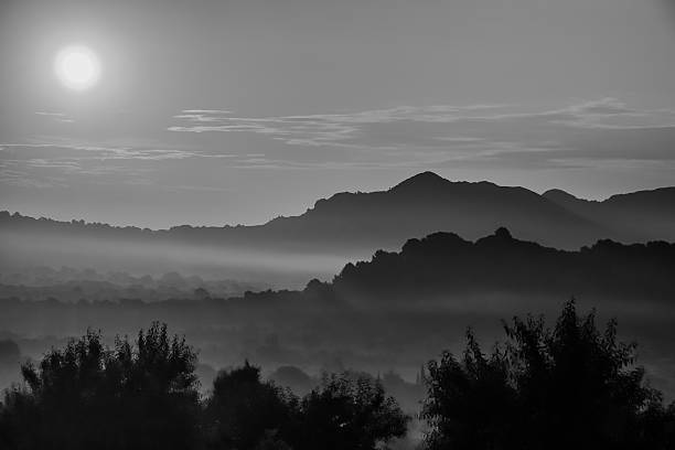 istock Silhouette Misty Landscape Against Sky 688984797