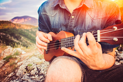 Man with ukulele outdoors