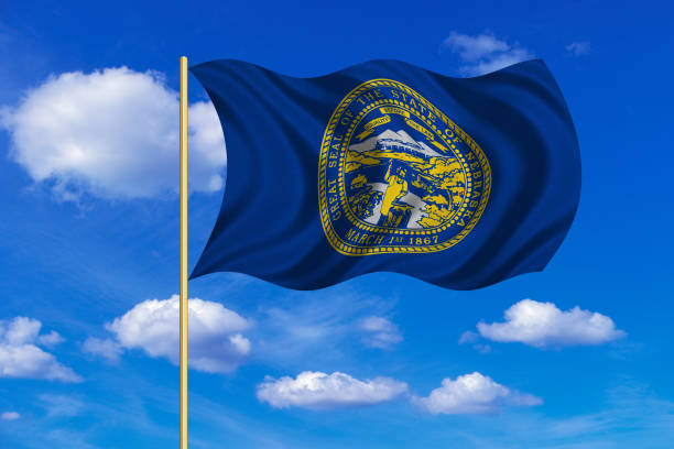 istock Flag of Nebraska waving on blue sky background 688992628