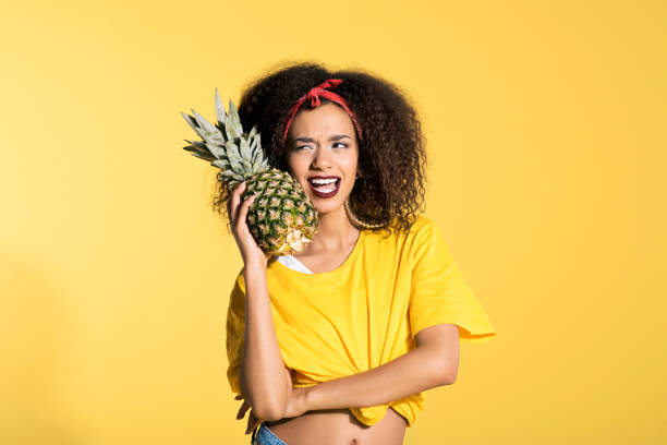 istock Happy young afro woman holding pineapple 688996466