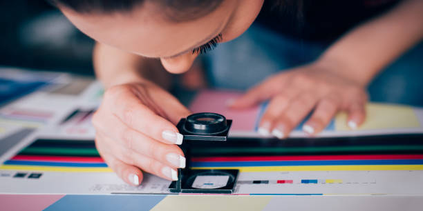 istock Worker in printing and press centar uses a magnifying glass 688999832