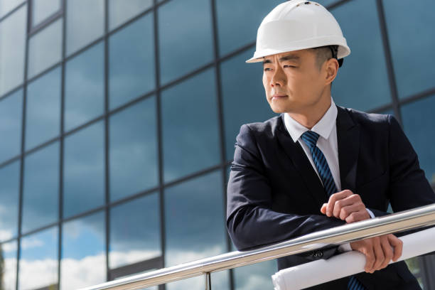istock portrait of professional architect in hard hat holding blueprint 689000314