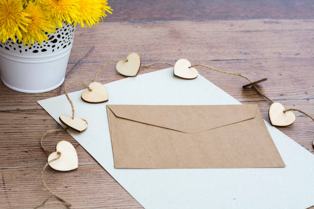 istock Empty letter with envelope. Wooden hearts and flower background 689001578