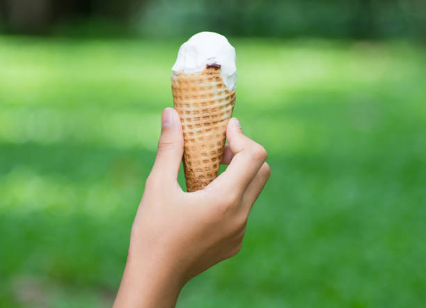 istock ice cream cone on girl hand 689004012