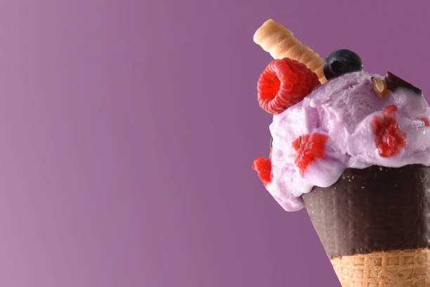 istock Ice cream cone flavored berries lilac background 689004344