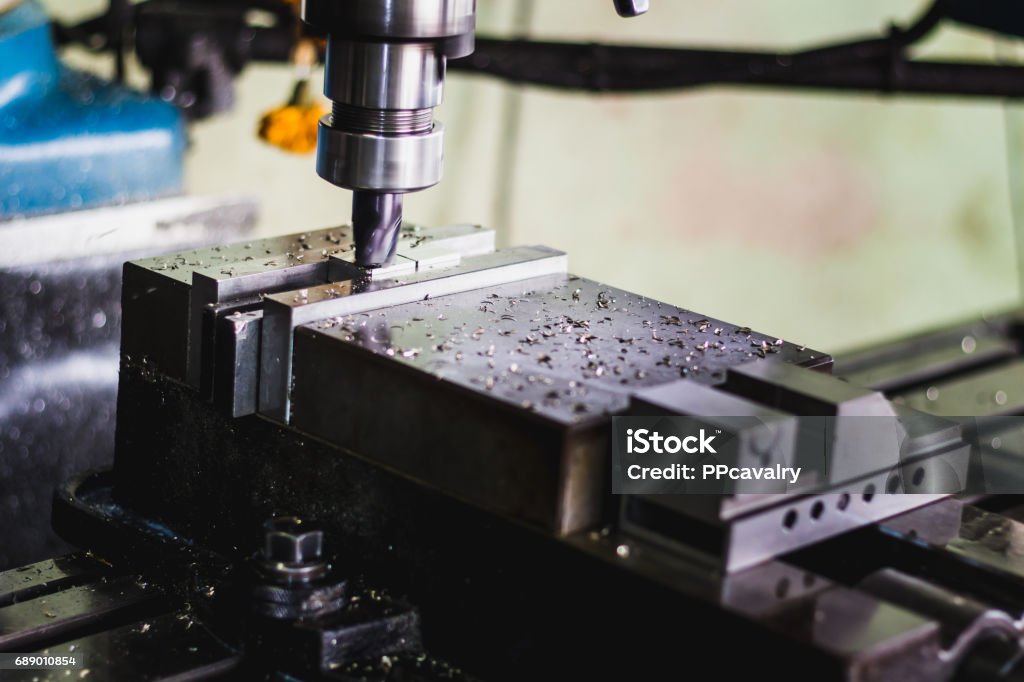 active milling machine during processing part of engine active milling machine during processing part of engine industry concept Accuracy Stock Photo