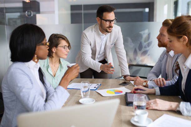 istock Businessman explaining business plan to coworkers 689011512